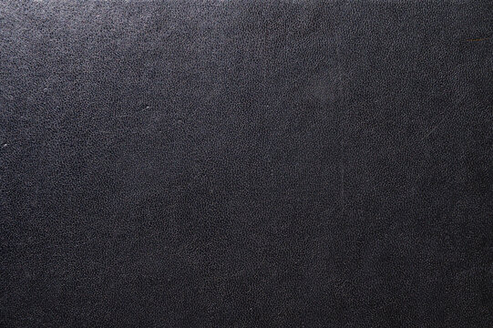 Black leather book cover close up. Abstract black leather sofa background.