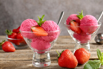 Tasty sorbet with strawberries and mint served on wooden table, closeup