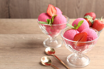 Refreshing sorbet, strawberries, mint and spoons on wooden table, closeup. Space for text