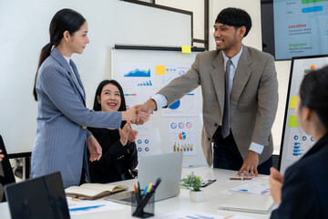 Business Professionals Shaking Hands in Meeting
