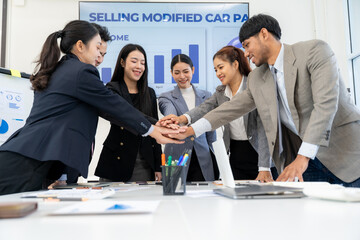 Diverse Business Team Stacking Hands in Meeting