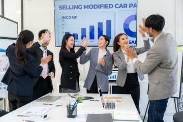 Business Team Celebrating Success in Meeting Room