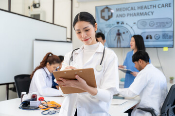 Fototapeta premium Asian Female Doctor Taking Notes in Medical Meeting