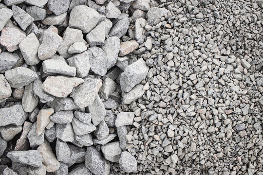 Various sizes of gray stone aggregate ready for construction at a building site