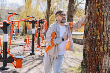 Senior man suffering heart attack during outdoor workout