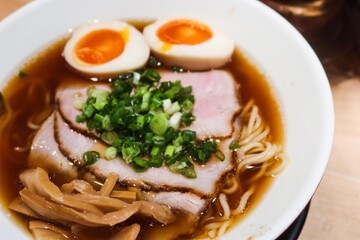 close up of Japanese ramen noodles with boiled Ajitsuke Tamago, spring onion and soft tender slice pork with noodles in soy sauce with copy space