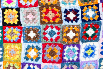 Multi colored blanket in wool, square geometric background, retro decorative pattern