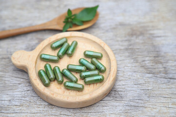 Herbal capsules from green herbal on leaf for healthy eating in daily life. capsules from watercress.