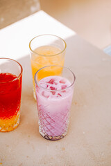 Refreshing summer drinks in colorful glasses on a sunny afternoon