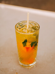 Refreshing tropical drink served in a glass with mint and citrus, perfect for a sunny day
