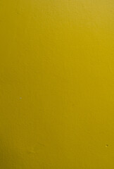 Yellow color old grunge wall concrete texture as background. Vertical image
