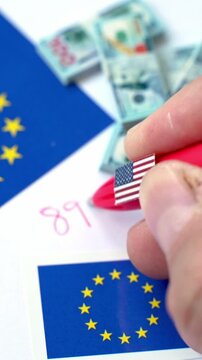 Hand writing 899 act regulation number near European union and USA flag with dollar banknotes, referring to US Tax Law Impacting EU-US Economic Relations