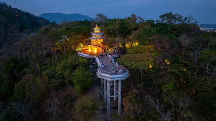 Aerial view of scenery Khao Rang viewpoint at twilight.
view of a town nestled among lush green mountains at sunset, with a Pavilion structure perched on the hillside at Phuket town at Dusk