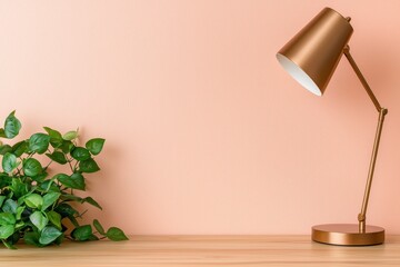 A stylish desk lamp beside lush greenery against a textured pink wall in a cozy space.