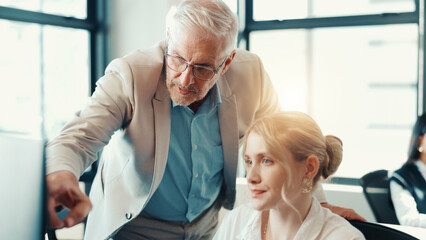 Business people, coach or pointing with computer at office for internship program or training staff. Businessman, mentor or helping junior intern with technology for new software, update or tasks