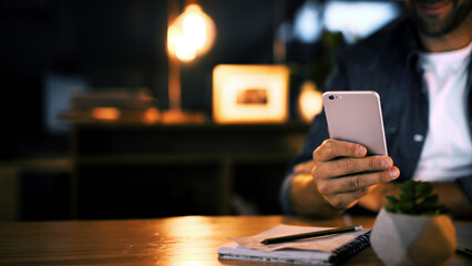 Hands, night and man in office, smartphone and message to contact, social media and communication. Person, closeup and employee in workplace, evening and cellphone with digital app for chatting
