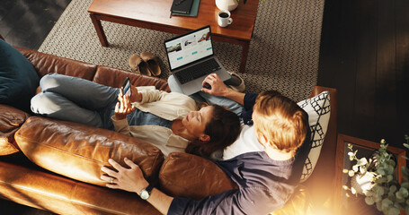 Laptop, phone and top view of couple on sofa for relax, chill and internet for bonding in home....
