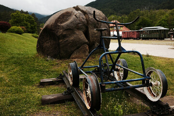 Old blue rail bike on display at Mokra Gora station in Serbia, surrounded by green grass in spring. Shargan - Sargan railway station.