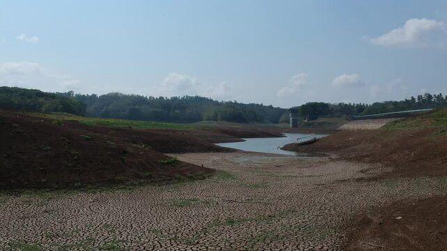 Bali, 23 Aug 2023: Palasari Dam in Jembrana, dries up due to severe drought triggered by El Ni&ntilde;o in 2023, exposing cracked soil and low water levels