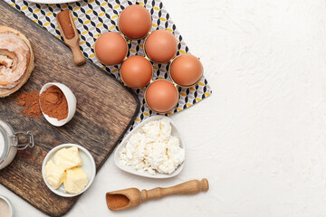 Different ingredients for preparing sweet cinnamon roll on white background