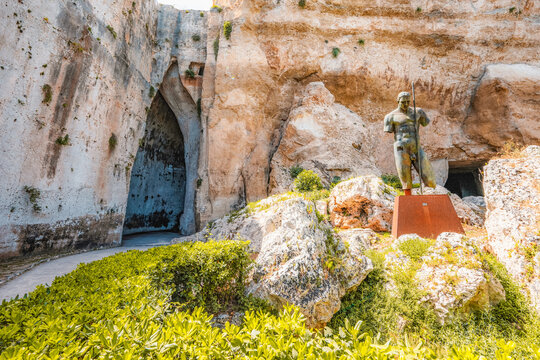 Greek theatre at Archaeological Park of Syracuse Sicily in the Neapolis archaeological park, Italy. Ear of Dionysius - Powered by Adobe