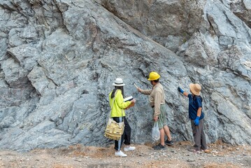 Geologists in the field examining rock formations