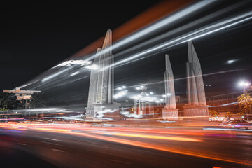 Thailand night life with scenery motion blur traffic in Bangkok at Democracy Monument near popular...