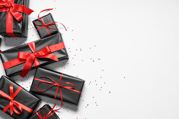 Gift boxes and confetti on white background. Black Friday sale. Top view
