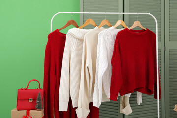 Obraz premium Rack with sweaters in hallway decorated for Christmas
