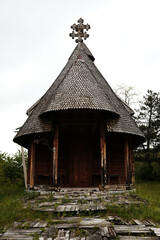 Traditional old wooden church on a hill under cloudy spring sky in Mokra Gora, Serbia.