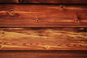 Wooden wall texture from a rustic building. Close-up of horizontal planks with natural knots and grains.