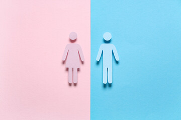 Male and female paper figures on color background