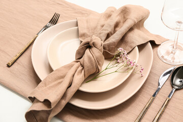 Beautiful table setting with gypsophila flowers on white background