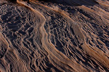 Rippled stone crevices catching the light.
