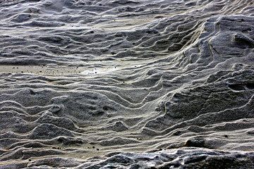 Intricate layers of rippled rock formations.