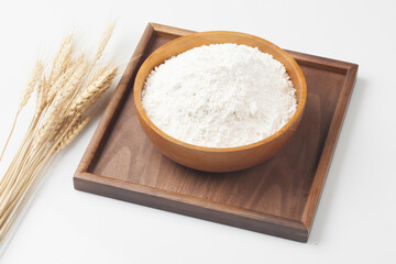 Flour is a powder made by grinding wheat.
