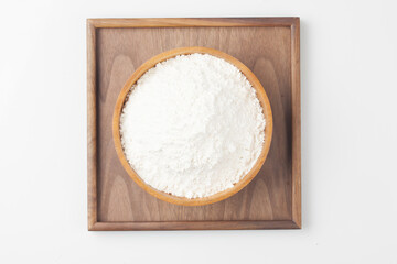 Flour is a powder made by grinding wheat.

