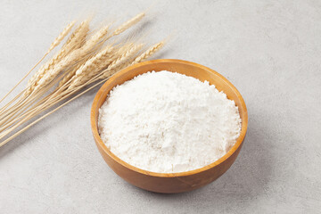 Flour is a powder made by grinding wheat.
