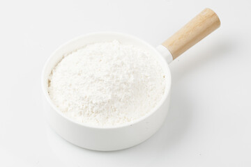 Flour is a powder made by grinding wheat.
