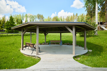 A Beautiful Scenic Outdoor Gazebo Elegantly Surrounded by Lush Greenery and Foliage