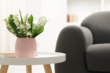 Bouquet of beautiful lily-of-the-valley on coffee table indoors. Space for text