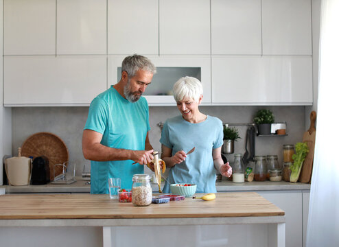 Portrait of a senior mature couple having a healthy breakfast after fitness exercise training in the morning at home