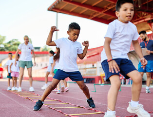 Young children having athletic exercise class running on the track, healthy lifestyle and children sport education concepts