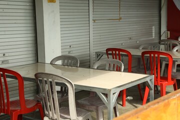 Empty tables and chairs in outdoor cafe