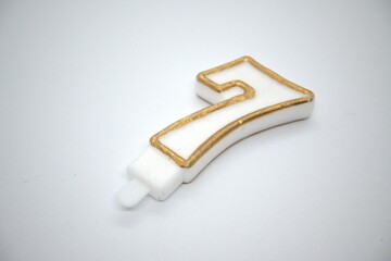 Number 7 birthday candle close up with white background.