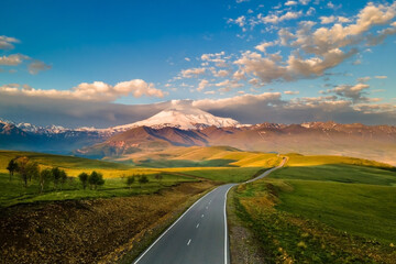 Elbrus mount with clouds at sunrise. Gil-Su valley in North Caucasus, Russia.