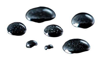 Close-up of several water droplets, dark background
