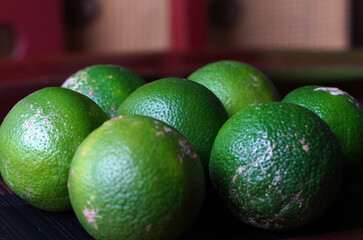 Green lemons on a table, fresh fruit, Costa Rica