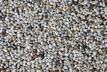 Fine Crimean pebbles texture for landscaping or construction with light-colored pebbles, copy space