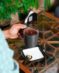 hands holding a cup of coffee